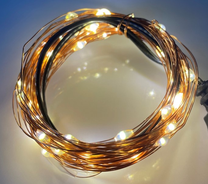 Coiled copper-coloured wire fairy lights illuminated with warm-white LEDs
